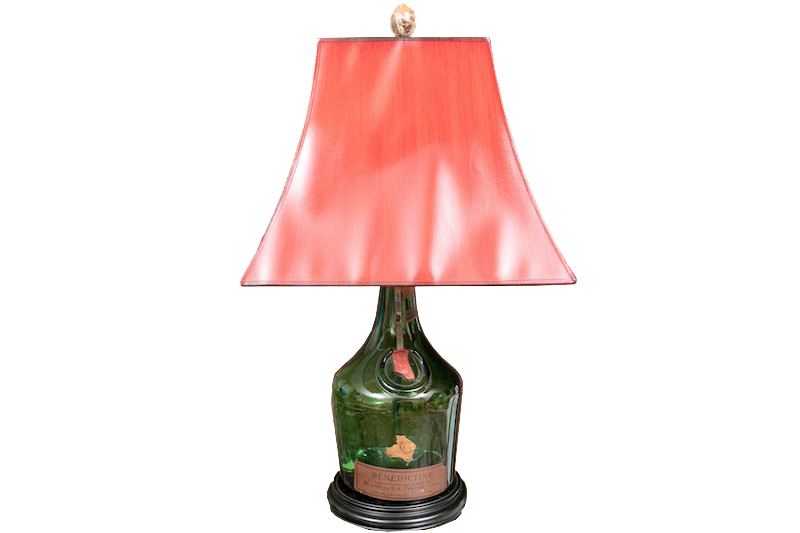 A vintage Benedictine Spirits bottle lamp with flared red shade